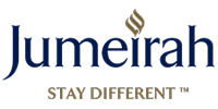 Jumeirah hotel brand logo with a gold flame emblem, navy blue script text, and the tagline Stay Different